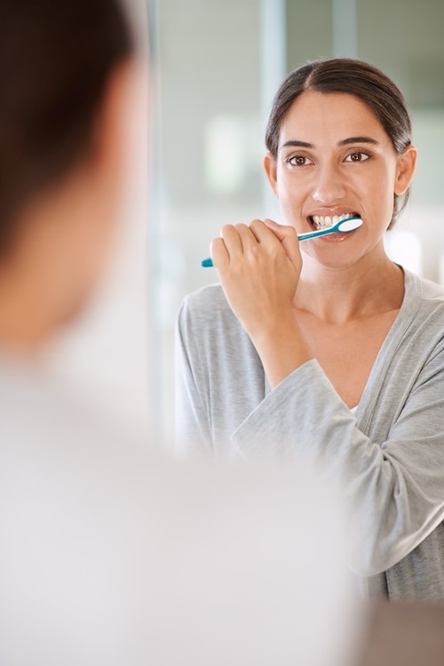 Woman Brushing Teeth Shutterstock 2434498289 1000